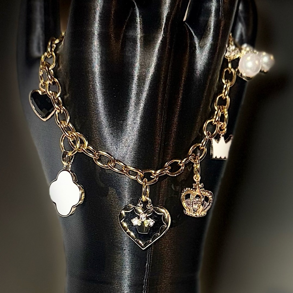 Elegant Gold Charm Bracelet With Black And White Accents